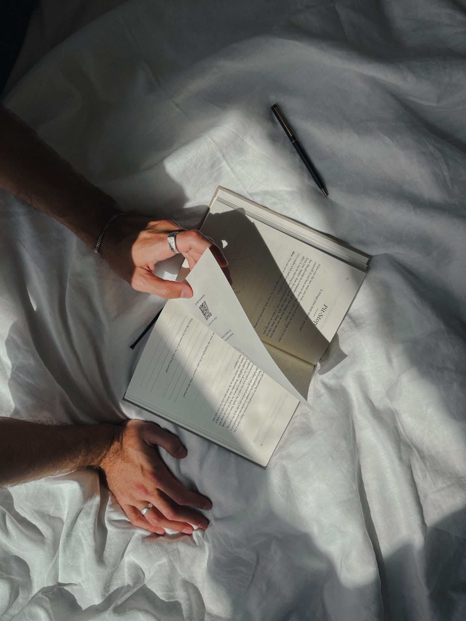 A linen-bound journal resting on a stone surface in morning light